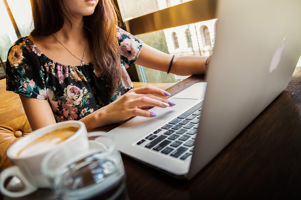 Working on a laptop with a coffee